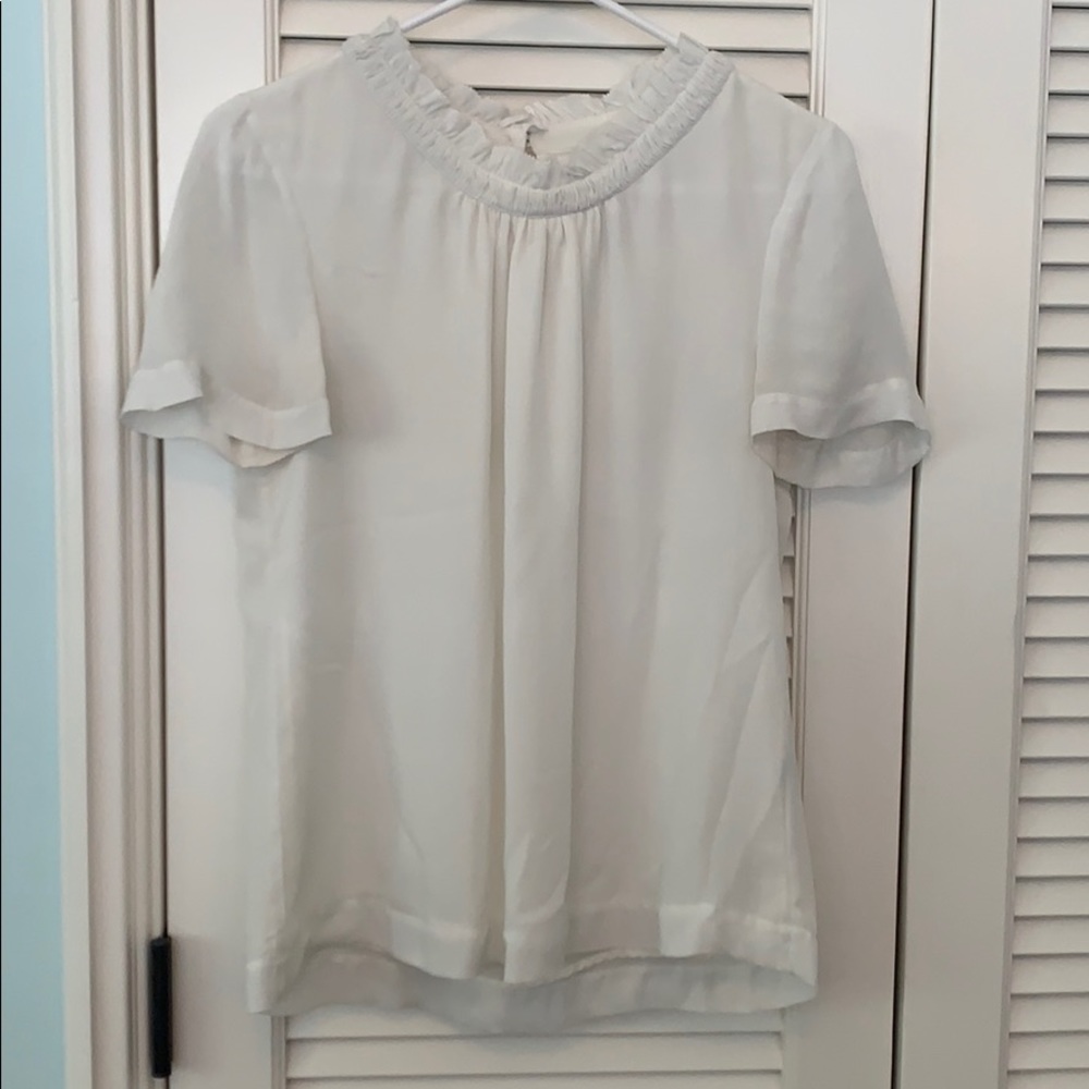 White blouse with bunching collar detail